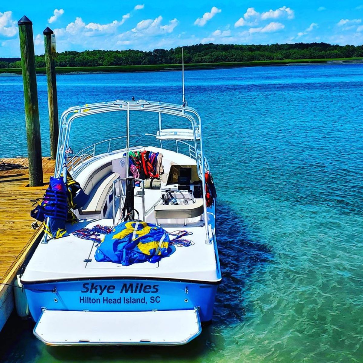 a blue and white boat floating on a body of water